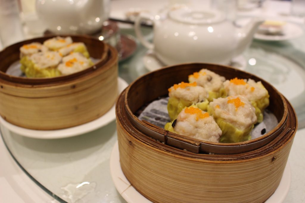 Dim sum on wooden bowls. If you're wondering what to do in Vancouver, going on a food tour and trying out different eateries is a good start.