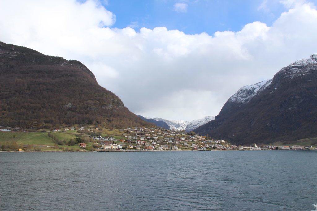 Village situated at the foot of a mountain by a fjord as seen during our Norway in a Nutshell tour