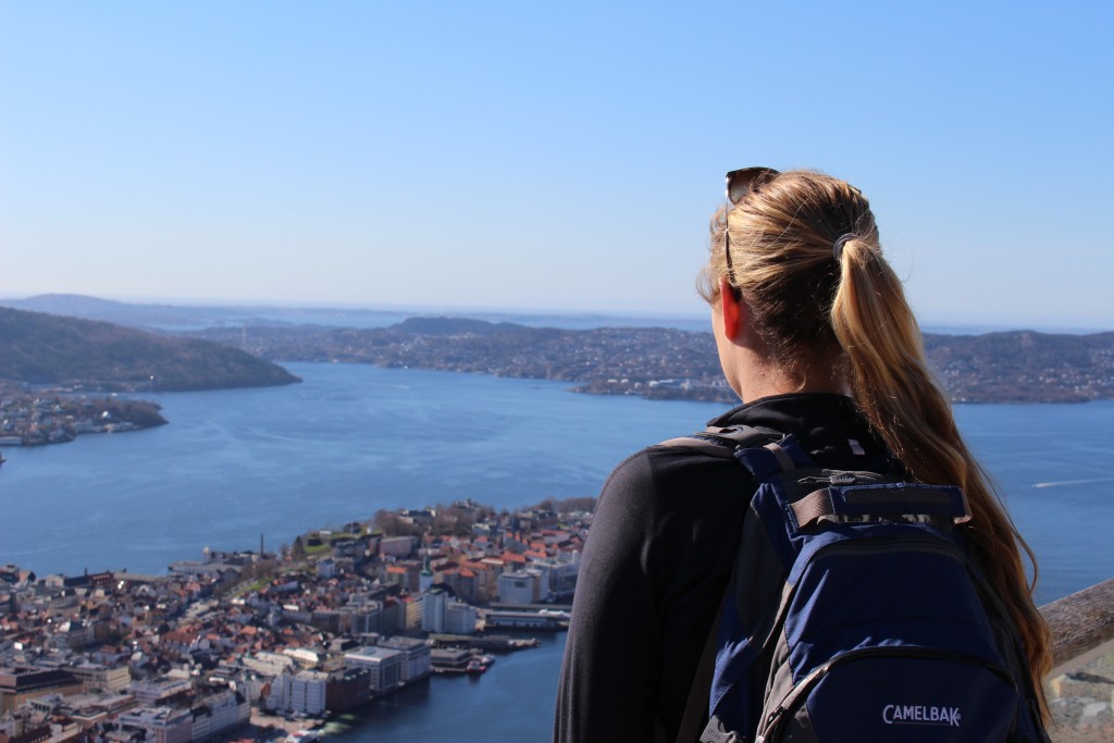 Maddy overlooking the town of Bergen from the top of Mt. Fløyen. Hiking in Bergen is one of the best hikes in Norway to put on your bucket list.