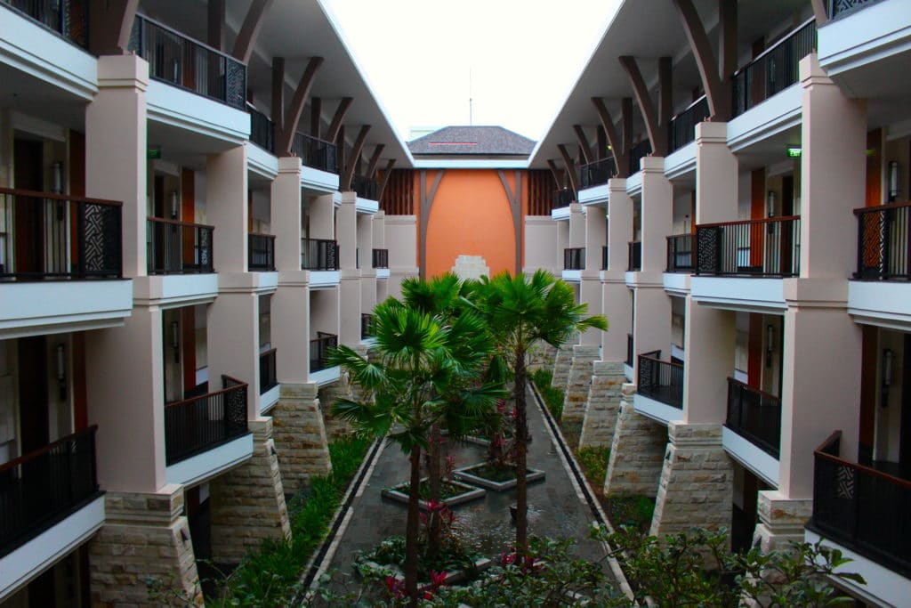 Garden trees planted on a space between two buildings of hotel rooms