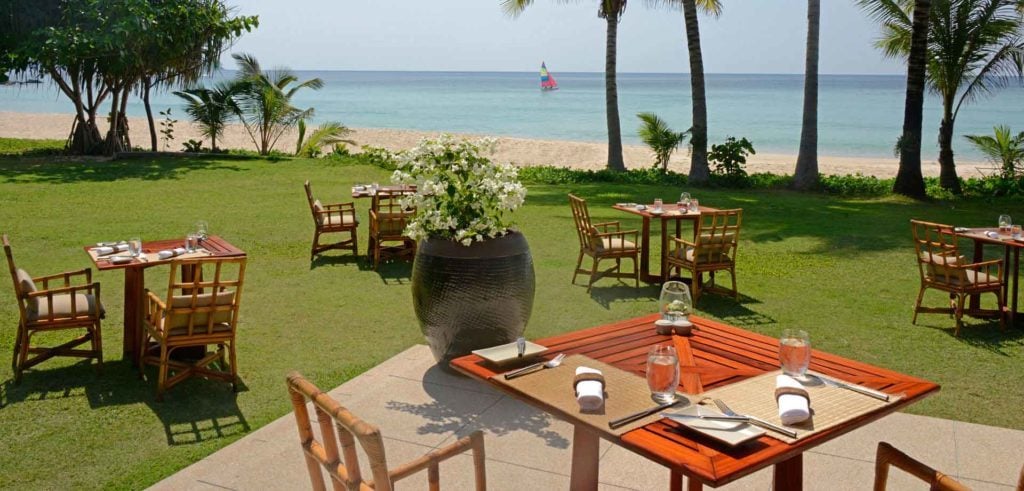 Outdoor dining area by the beach at The Surin Phuket - one of the best resorts & hotels in Phuket for your luxury tropical escape