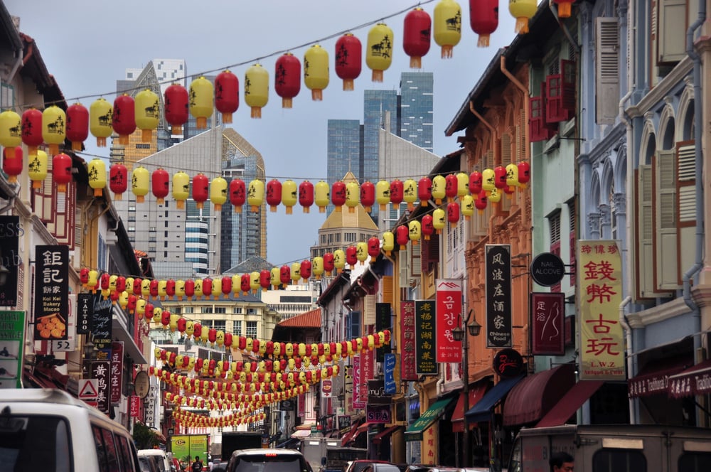 Colorful lanterns strewn across a colorful street in Chinatown in Singapore