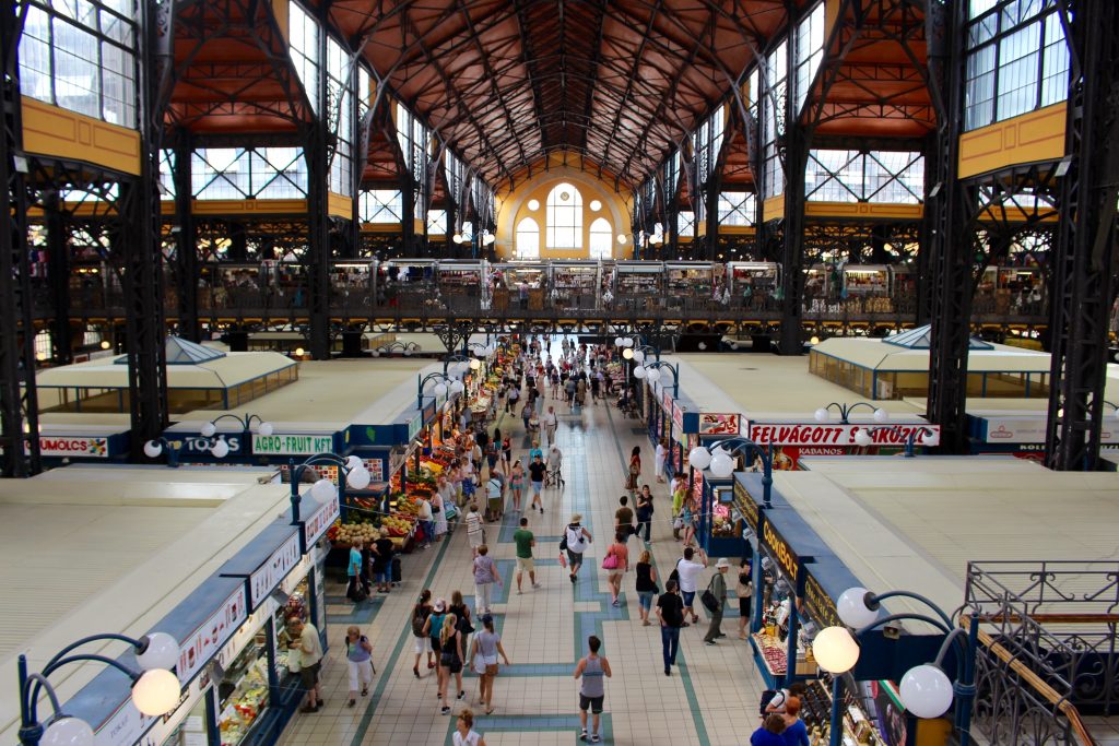 Crowd of people at the Central Market Hall. Exploring food stalls and shops at this place if one of the top 25 things to do in Budapest.