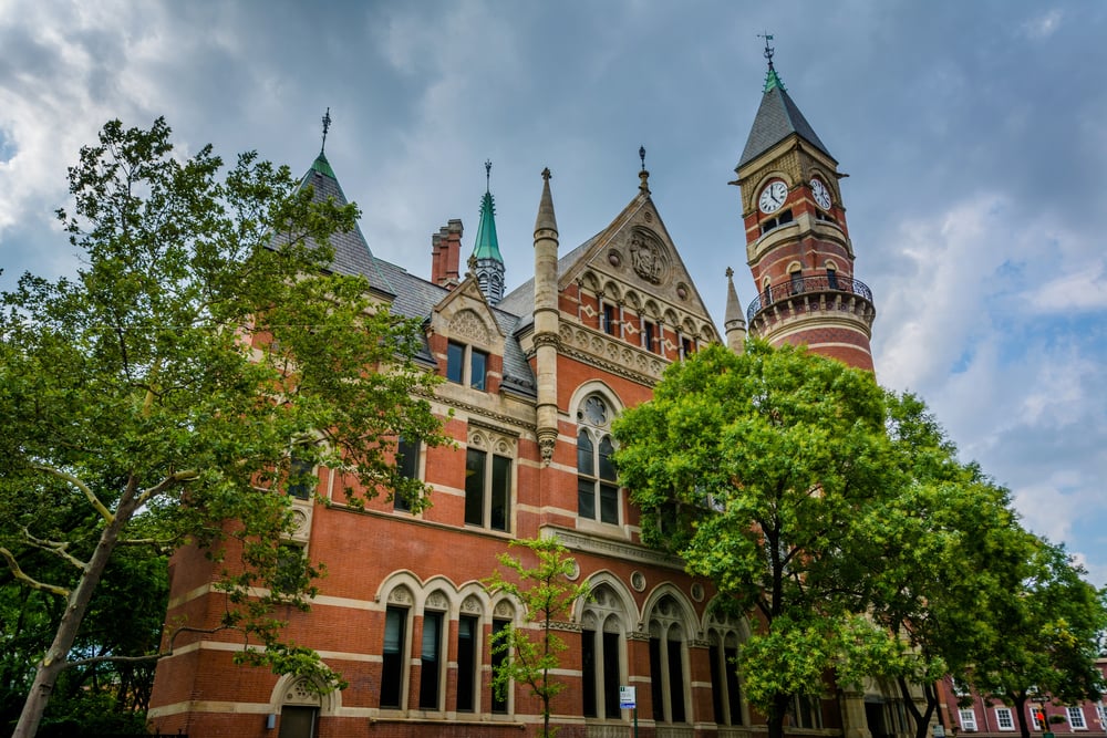 Jefferson Market Library with green trees and a partly cloudy sky