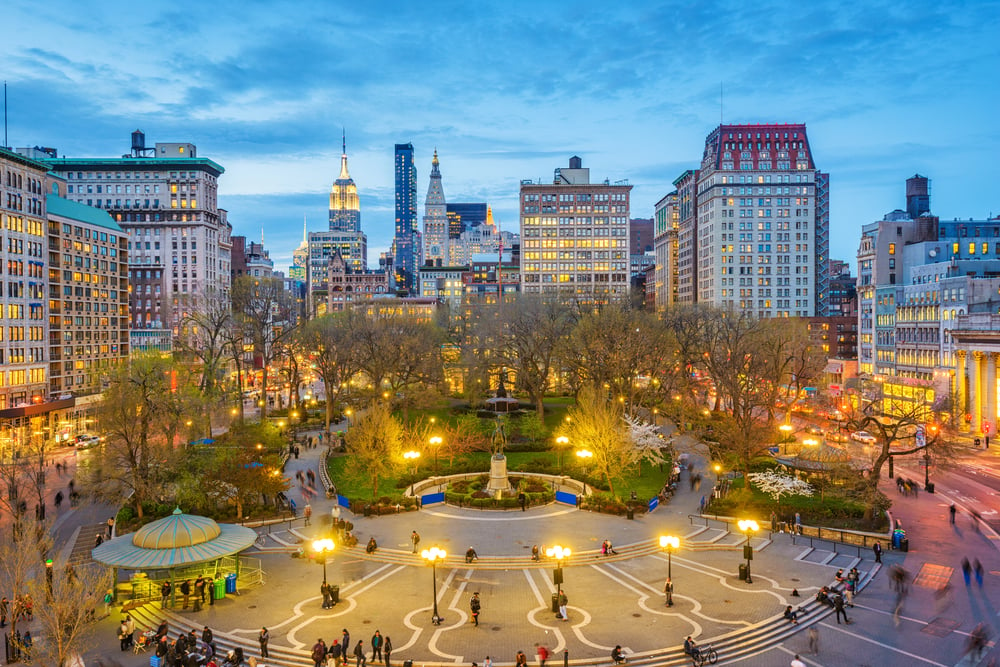 Union Square in New York at sunset with the lights on