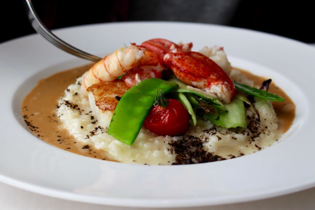 Canadian lobster dish with seared scallops and langoustine, served atop a parmesan risotto and crawfish cream - the main course of our fine dining in Prague