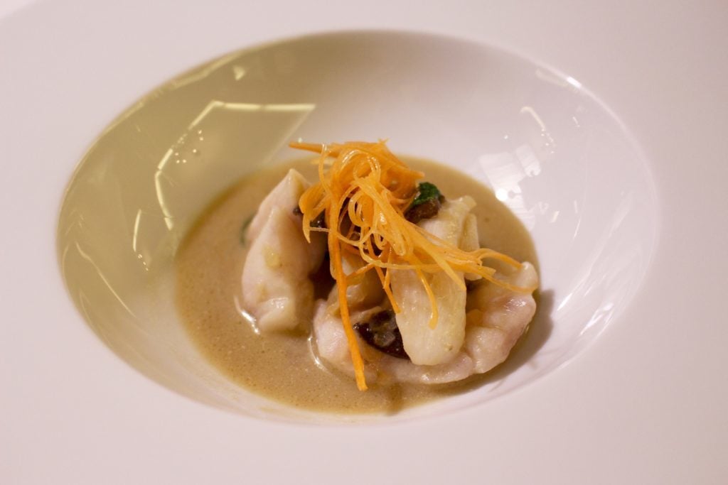 Monkfish cheeks with tarragon velouté, fresh carrot, and shiitake