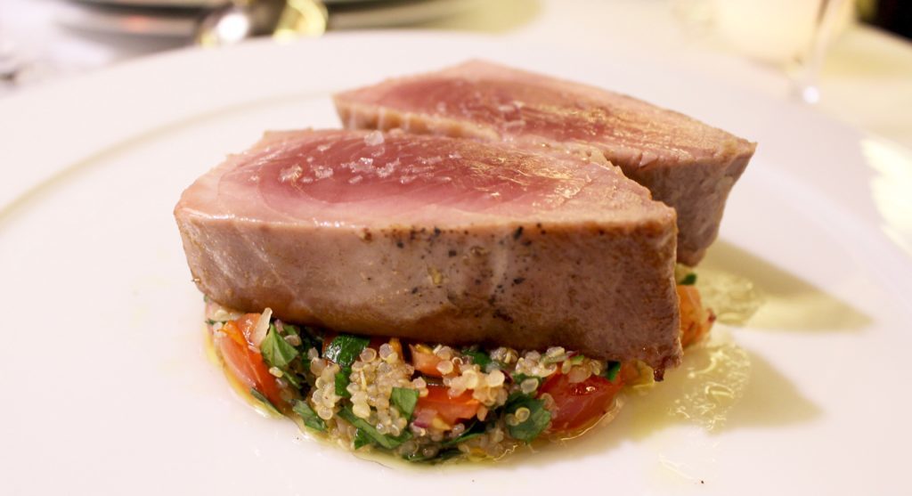 Seared medallions of yellowfin tuna with organic quinoa a la tabouleh, baby pak choi, enoki, and a lemon vinaigrette - the second course of our fine dining at CODA Restaurant, a rooftop bar in Prague