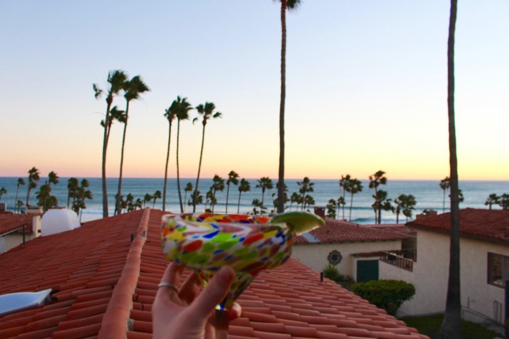 Holding up a colorful glass of margarita while enjoying the beautiful view of the beach from the hotel balcony. We enjoyed this gorgeous view while talking about how happy we were on our road trip to Baja California.