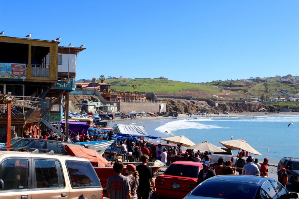 People gathering at the beachfront market in Popotla. Learn how to road trip to Baja California in this guide.