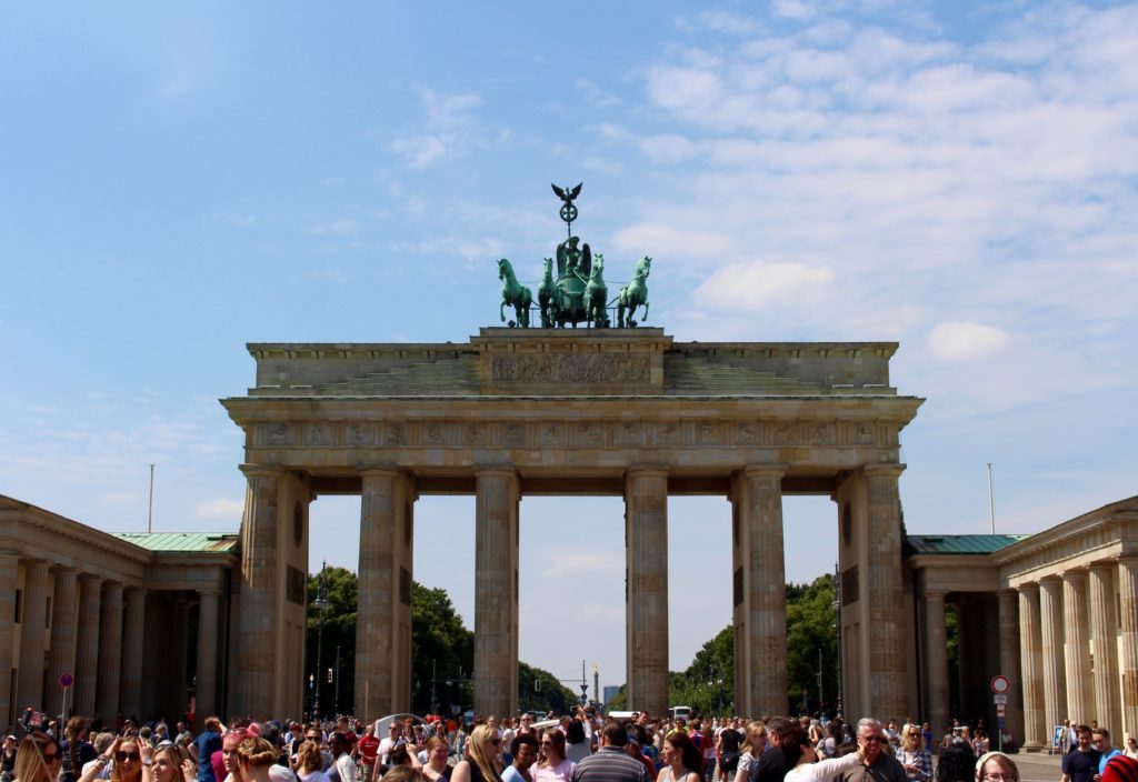 Crowd of people roaming below the iconic Brandenburg Gate