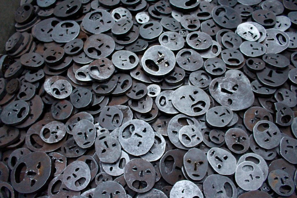 Thousands of iron faces called Fallen Leaves, an exhibition at a Jewish Museum in Berlin