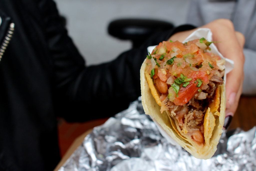 Holding a delicious taco. One of the underrated things to do in San Francisco is to eat at Mexican restaurants.