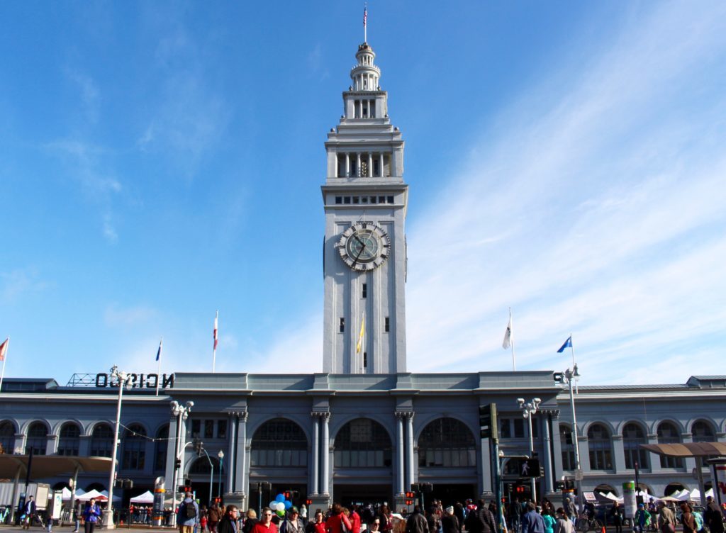 Crowds of people roaming around the San Francisco Ferry Building. One of the underrated things to do in San Francisco is visiting one of its biggest marketplaces.