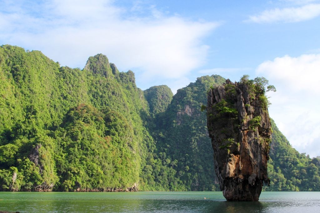 Smaller rock formation in the middle of the sea while island hopping in Thailand