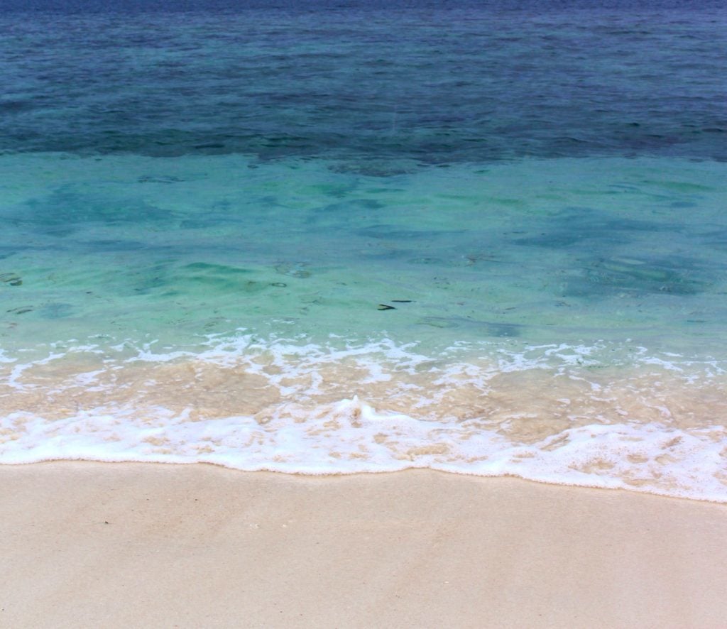 Pristine ocean waters by the beach during island hopping in Thailand