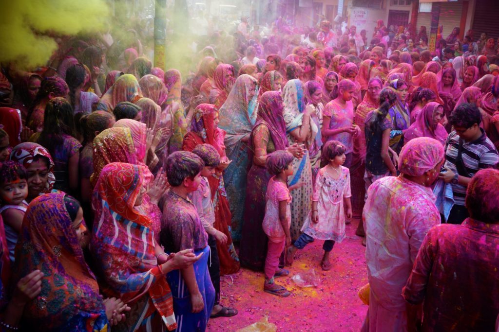 Colorful powder on people's faces and clothes as they celebrate the Holi Festival in India
