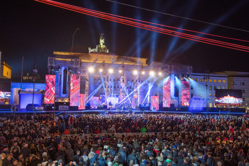 People celebrating New Year's Eve in Berlin, Germany. This party is one of the 20 festivals to experience in your 20s.