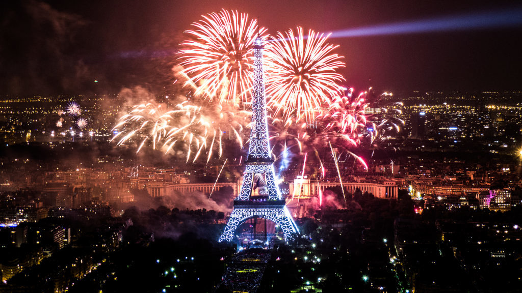 Beautiful fireworks display on top of the Eiffel Tower during Bastille Day