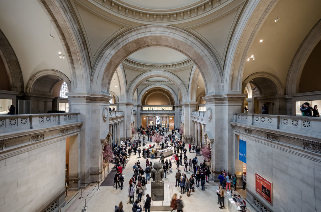 People exploring the Met in NYC. Visiting here is one of the best things to do in New York City. 