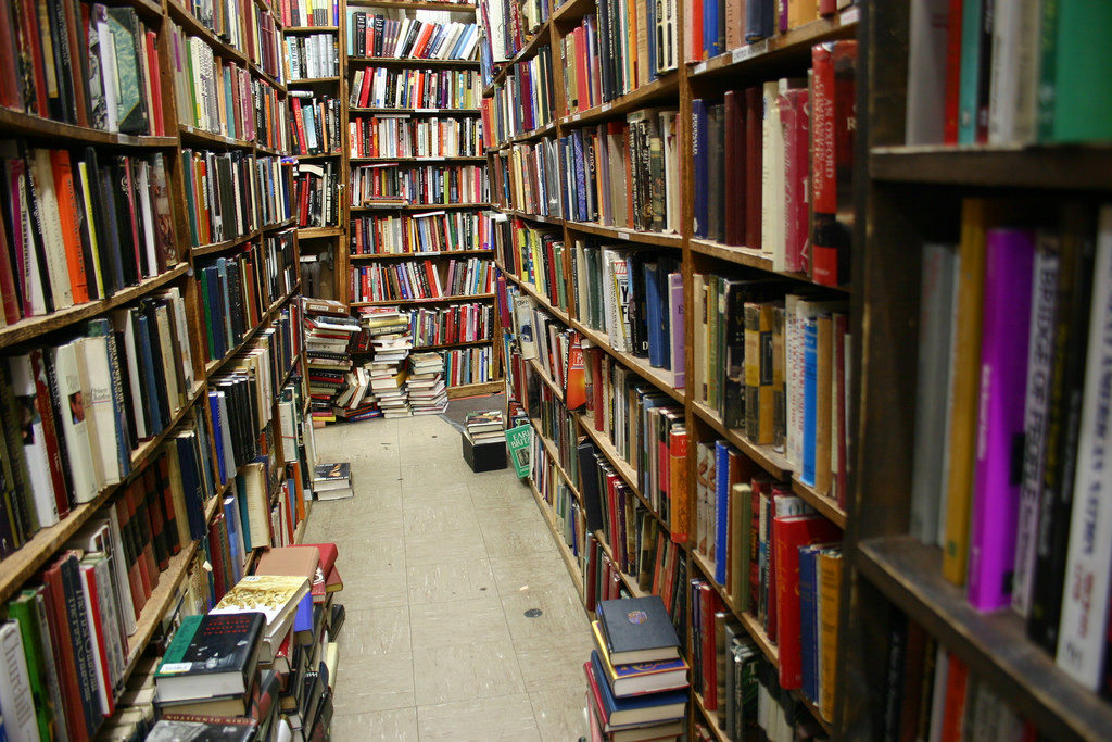 Tons of books on shelves in a bookstore in NYC