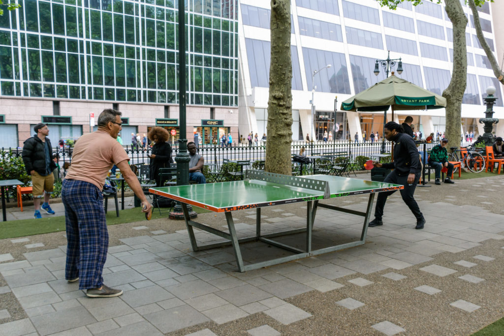 People playing each other in ping pong at Bryant Park in NYC