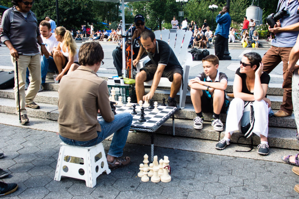 People playing chess in Union Square in NYC. People watching here is one of the best things to do in New York City - and a must-add to your NYC bucket list. 