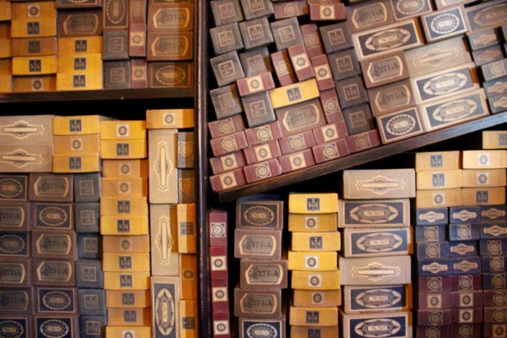 Dusty boxes of wands piled up in shelves inside Ollivanders. Visiting The Wizarding World of Harry Potter won't be complete without a trip to Ollivanders.