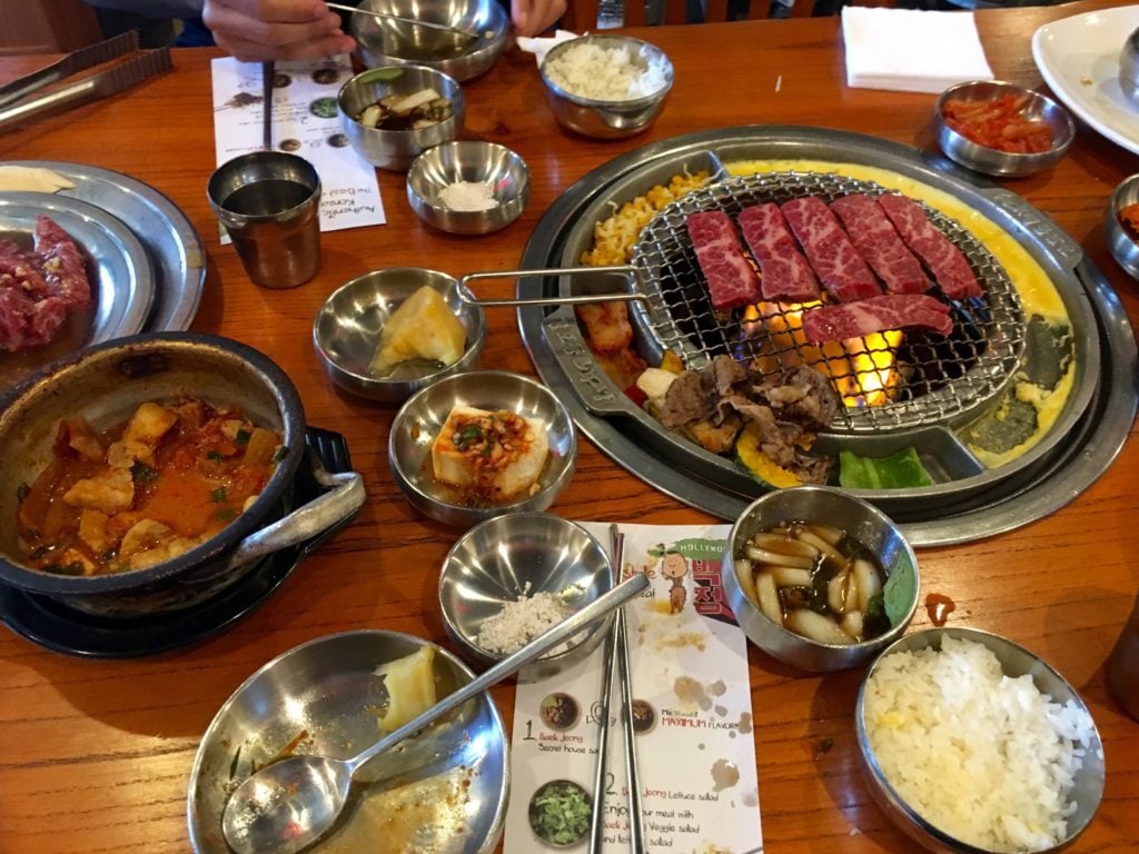 Cooking food at the table at a Korean BBQ restaurant in NYC