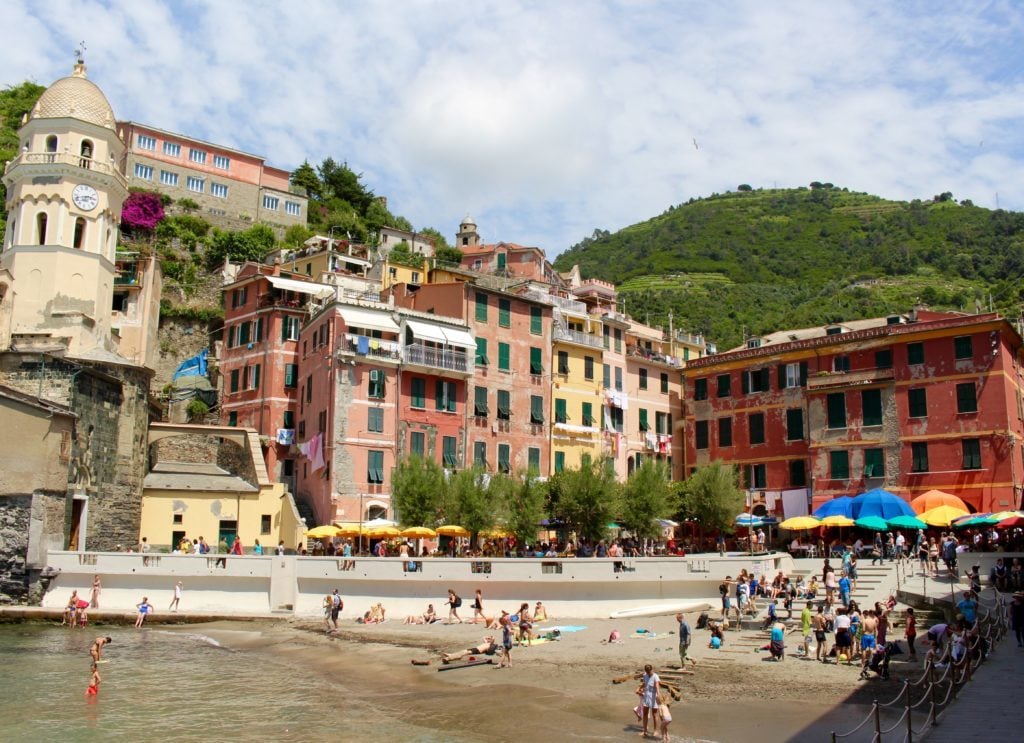 People on a small beach in Vernazza on a sunny day. While hiking in Cinque Terre, we decided to swim at the nearby beach to rest for a while.