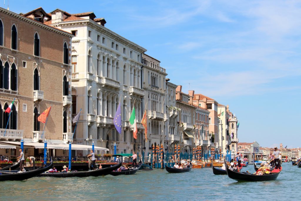Gondolas along the canal in Venice. If you want to know if a gondola ride in Venice is worth it, check the different prices offered by other tours.