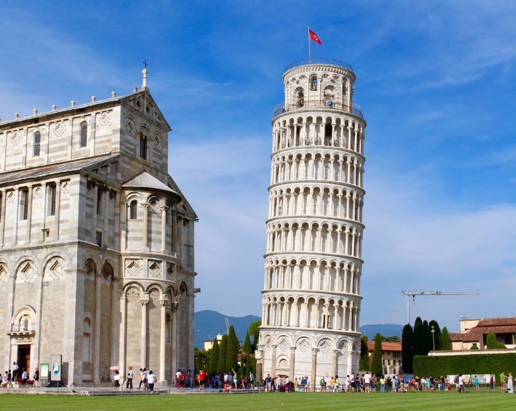 The iconic Leaning Tower of Pisa surrounded by tourists