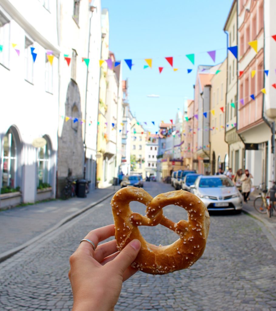Holding up a pretzel while roaming around Regensburg - one of the fairy tale towns in Germany