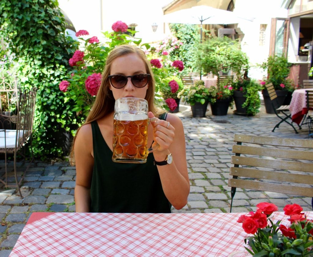 Maddy drinking beer in Regensburg, Germany. Taste world-renowned cuisine and local beers during your Viking River Cruises Grand European Tour.