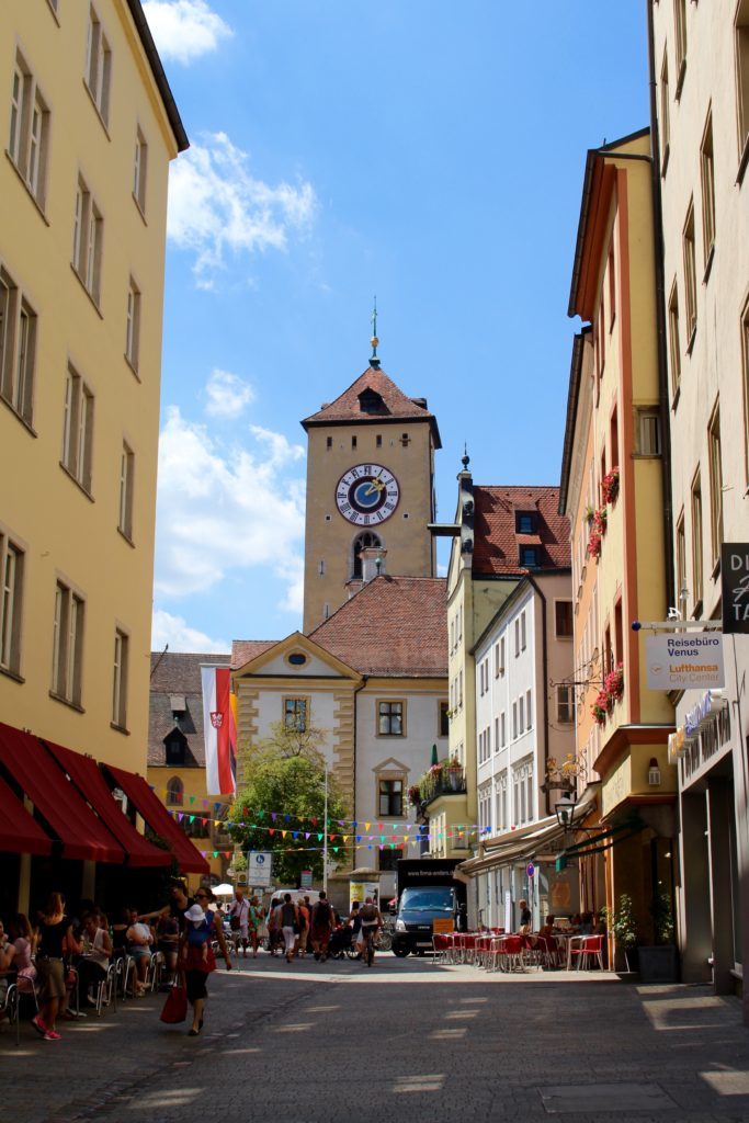 Crowded street and buildings near the Clock Tower at Regensburg - one of the fairy tale towns in Germany
