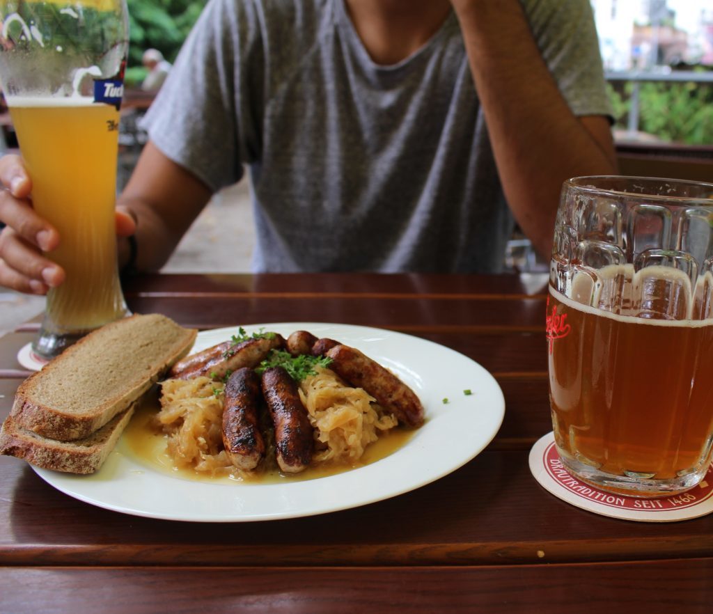 Bratwursts, loaf bread, and beer in a biergarten at Nuremberg - one of the fairy tale towns in Germany