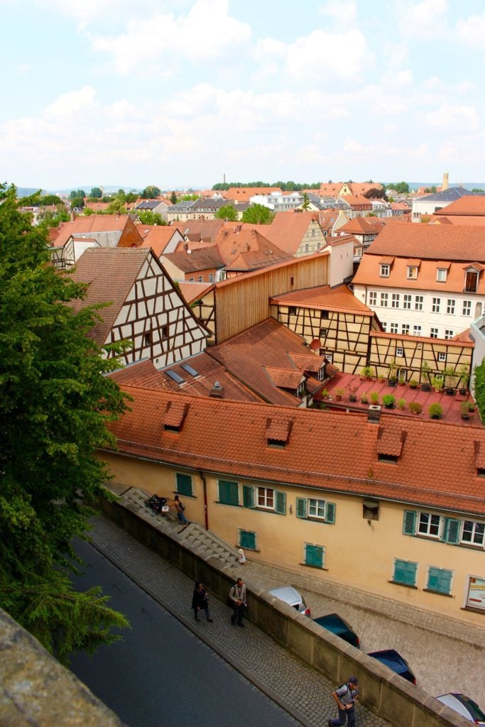 View of the red roofs of buildings in Bamberg. Make sure to do your research on things you need to know before you visit Bamberg so you can make the most of your vacation.