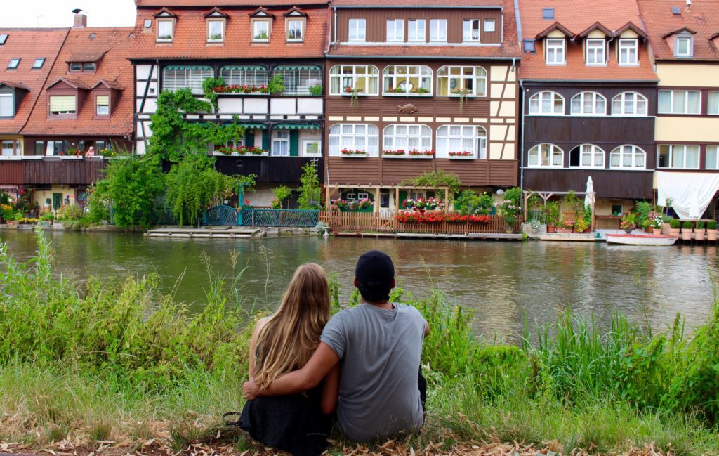 Maddy and Mauricio sitting by the river in Bamberg, Germany