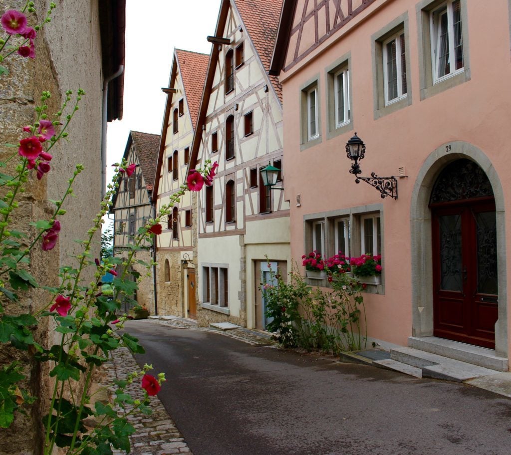 Old houses decorated with lovely flowering plants. The beautiful streets with medieval houses is one of the main sights and attractions in Rothenburg ob der Tauber.