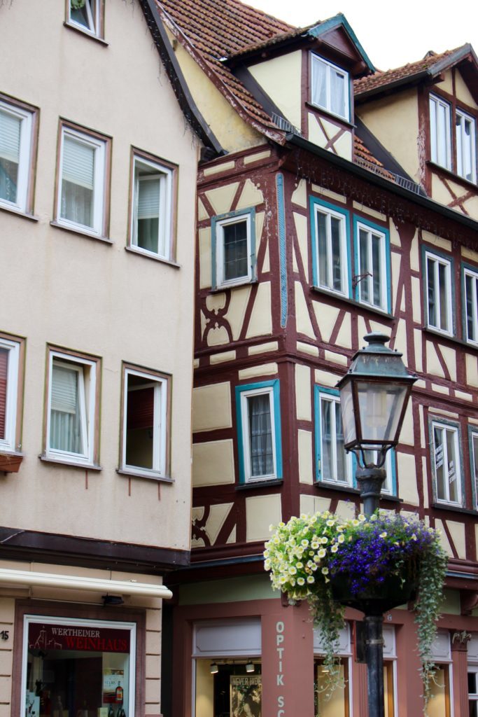 Medieval buildings in Wertheim painted in yellow with brown lines. The town of Wertheim is one of the best places to visit in Germany.