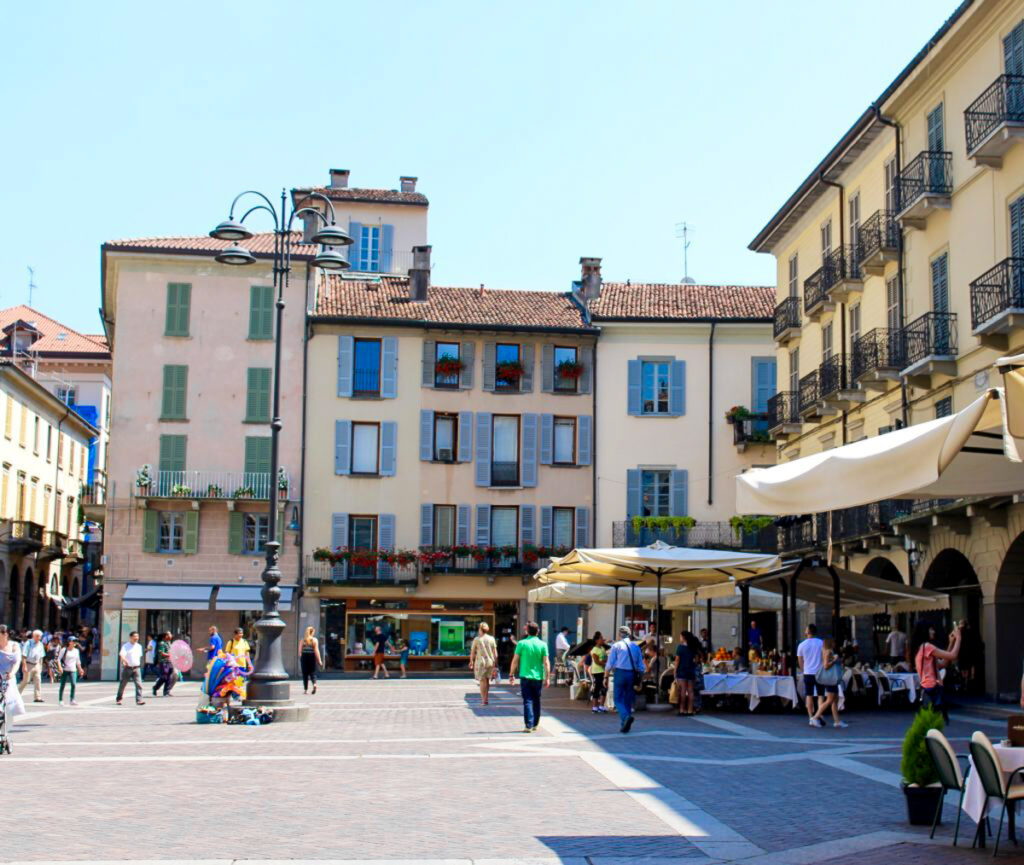 The main piazza in Como, buzzing with people. Como is one of the must-see towns on a day trip from Milan to Lake Como.