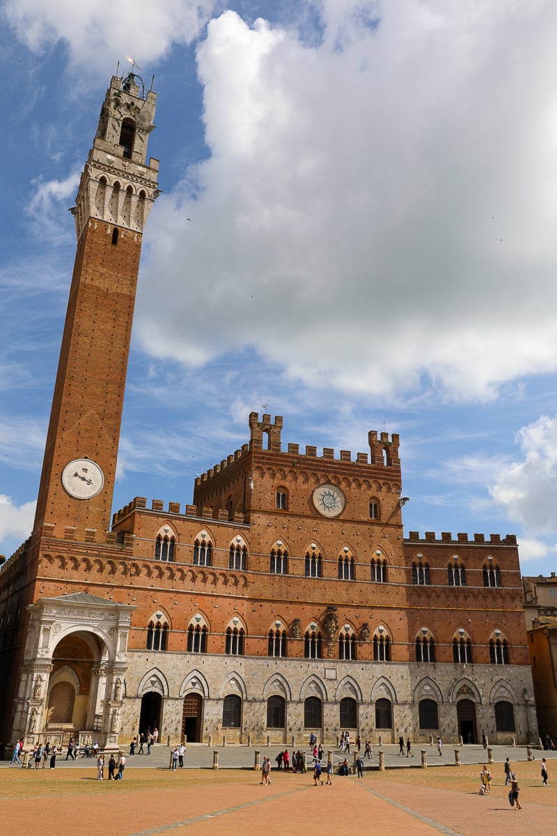 Torre del Mangia, an iconic clock tower in Siena that you should not miss during your Tuscany In One Day sightseeing tour