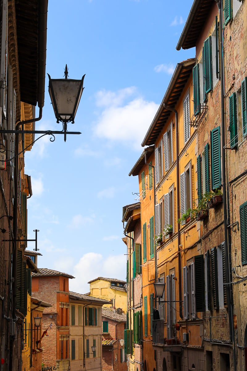 Quaint neighborhood in Siena, Italy. Don't miss the chance to explore this beautiful city during your Tuscany region day trip.