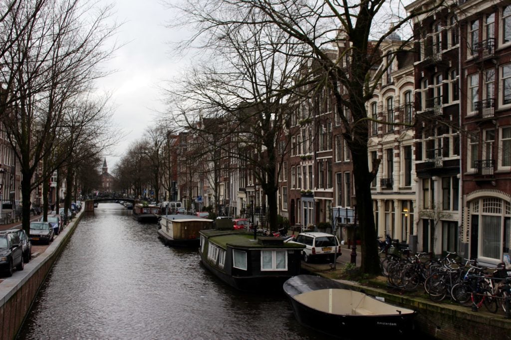 Boats docked by a canal in Amsterdam, Netherlands - one of the destinations of our Viking River Cruises Grand European Tour