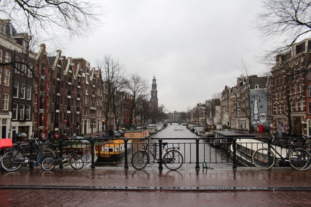 Bicycles parked on a bridge's fence in Amsterdam, Netherlands. Trace the majestic shores between Amsterdam and Budapest on your Viking River Cruises Grand European Tour.