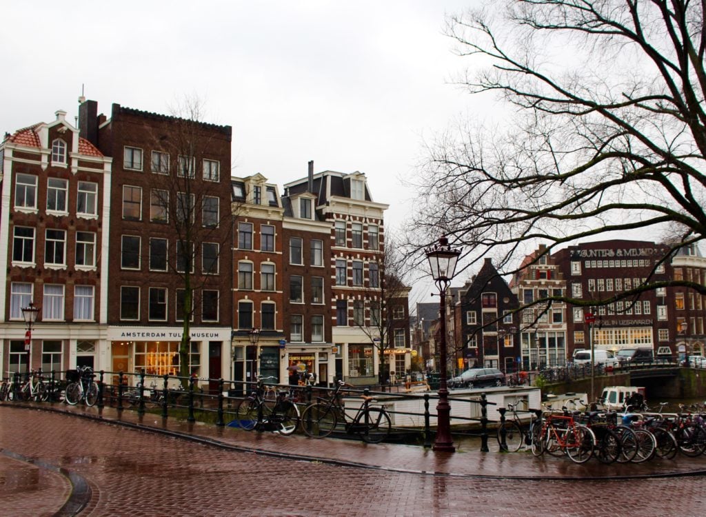 Bicycles lining the fences in Amsterdam, Netherlands on a rainy day