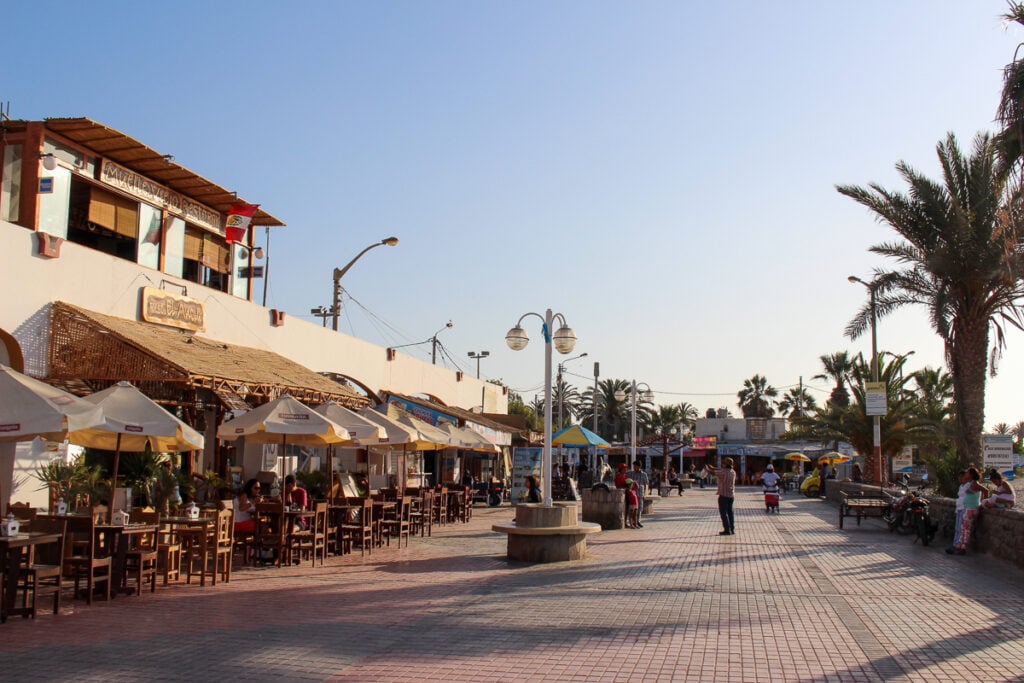 Stores with outdoor seating area on a late afternoon in Paracas