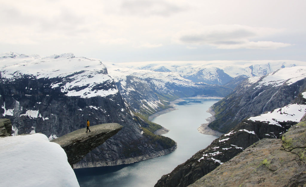 Hiker on the edge of Trolltunga in Norway