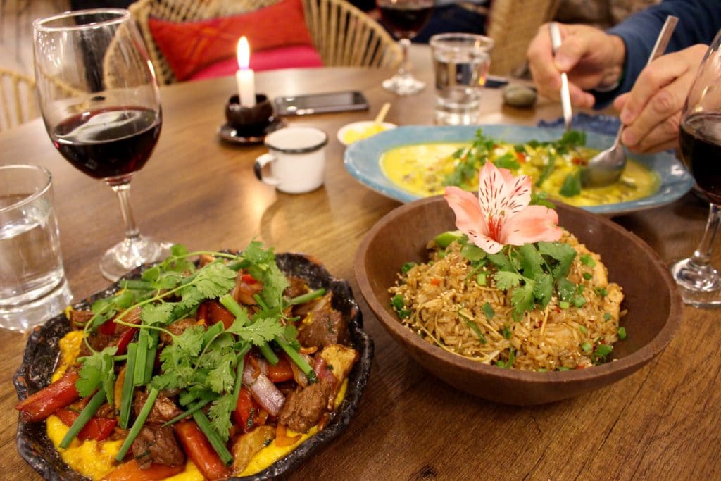 A dish of lomo saltado and tacu tacu criollo served on wooden plates at the Moreno Peruvian Kitchen restaurant