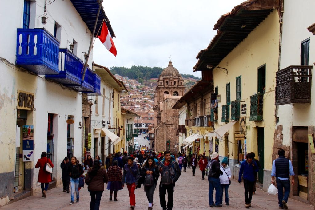 Crowds of people walking on a wide street. In this Cusco travel guide, you'll find my recommended places to stay in during your three days in Cusco.